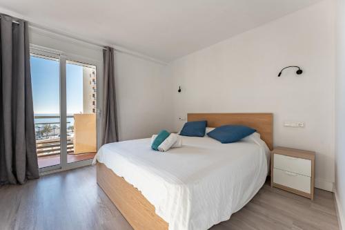 - une chambre avec un grand lit et une grande fenêtre dans l'établissement Espectacular Vista Al Mar, à Fuengirola