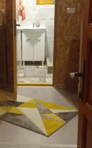 a bathroom with a sink and a rug on the floor at Planinski Mir in Pale