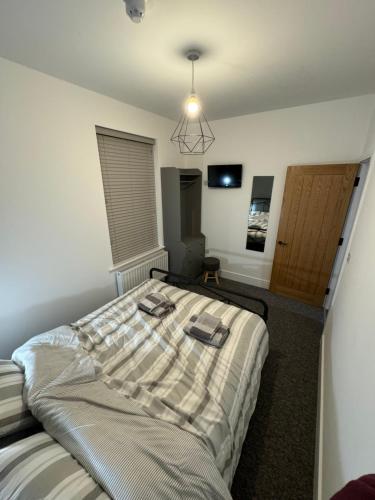 a bedroom with a bed with towels on it at Flat 2,Gelli Gaer in Aberystwyth
