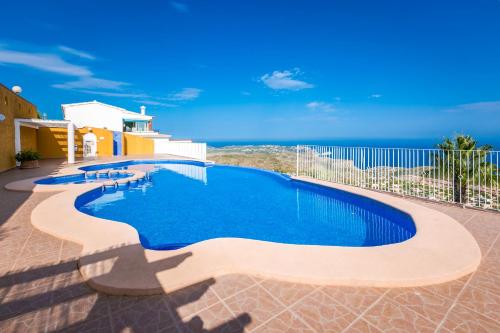a swimming pool with a view of the ocean at Panoramic Apartment in Cumbre del Sol
