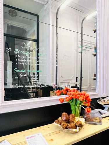 a counter with a table with bread and a window at 22b&b in Antwerp