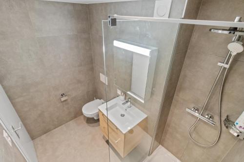 a bathroom with a shower and a sink and a toilet at Studio cosy au centre de Crans-Montana in Crans-Montana