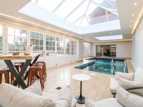 a house with a swimming pool and a skylight at Otherton Hall in Stafford