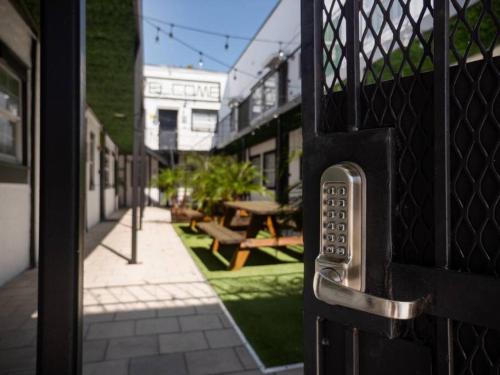 an open door to a courtyard with a picnic table at Modern Westshore in Tampa