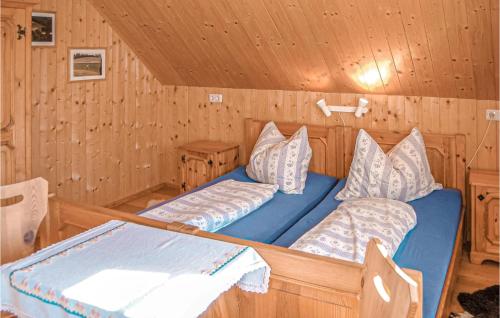 a bedroom with two beds in a log cabin at Ferienhaus Bad St, Leonhard in Bad Sankt Leonhard im Lavanttal