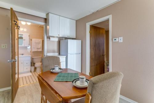 a dining room table with two chairs and a white refrigerator at Aurora Horse Farm Apartment Near Denver! in Aurora