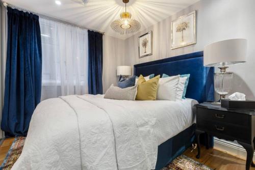 sypialnia z dużym łóżkiem z niebieskim zagłówkiem w obiekcie VAQUAY Mon Tresor In Melbourne CBD w Melbourne