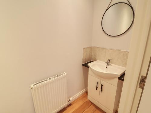 a bathroom with a sink and a mirror on the wall at Spring Rose in Bedale