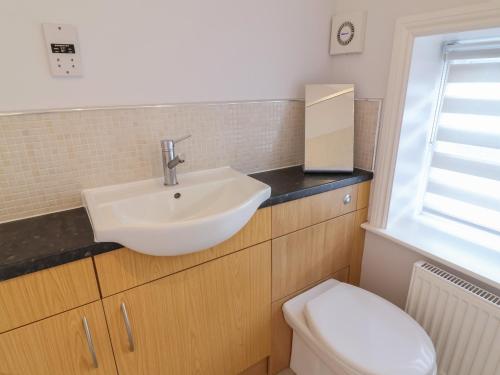 a bathroom with a sink and a toilet at Spring Rose in Bedale