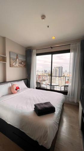 a bedroom with a large bed with a stuffed animal on it at The base Central 1006 by Numam in Pattaya
