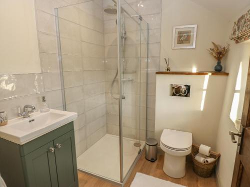 La salle de bains est pourvue d'une douche, de toilettes et d'un lavabo. dans l'établissement The Farmhouse, à Keighley