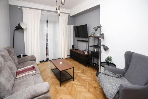 a living room with two couches and a coffee table at Perfect Long-term Stay Stylish and Spacious Top Center Next to Vitosha Blvd in Sofia