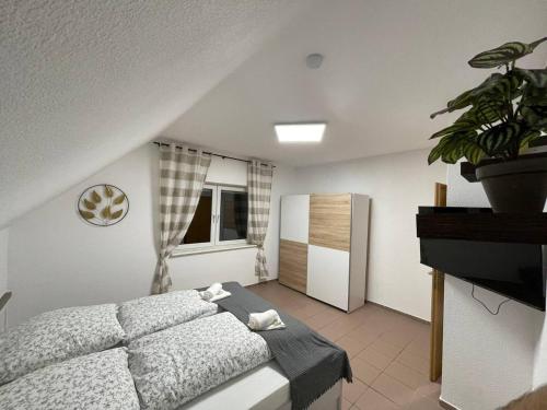 a bedroom with a bed and a potted plant at Rheinview Urbar Haus in Urbar