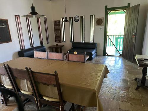 a living room with a table and a couch at Quinta do Conde in Lauro de Freitas