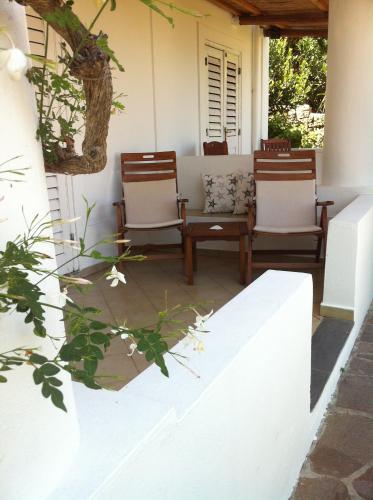 two chairs and a table on a porch at Hotel O Palmo in Panarea