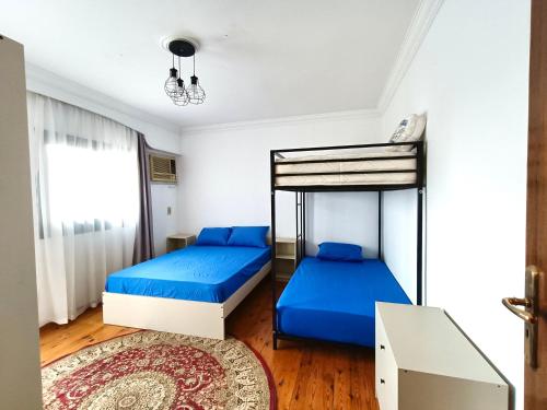 two bunk beds in a room with a rug at Luxury 2 bedroom apartment at the heart of modern Cairo directly on Salah Salem main street in Cairo