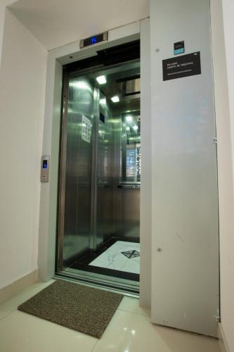 a glass door in a building with a sign on it at Hotel Riviera Inka Paracas in Paracas