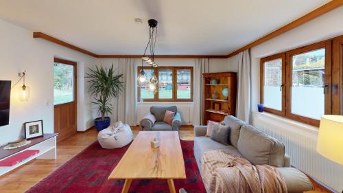 a living room with a couch and a table at Haus Alberto - Haus mit 2 Ferienwohnungen in Ötztal-Bahnhof