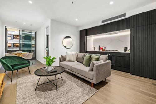 a living room with a couch and a table at Riverview Parkhouse Abbotsford in Melbourne