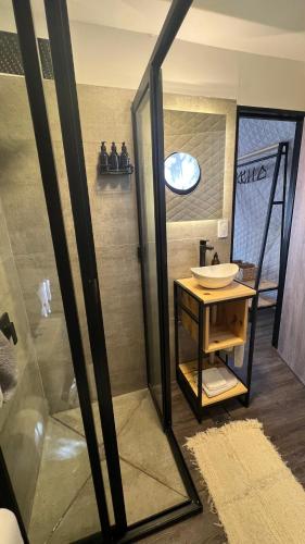 a bathroom with a sink and a shower at Deer Glamping in Ciudad Lujan de Cuyo