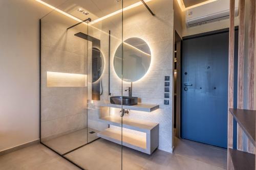 a bathroom with a sink and a mirror at Acropolis View Suites in Athens