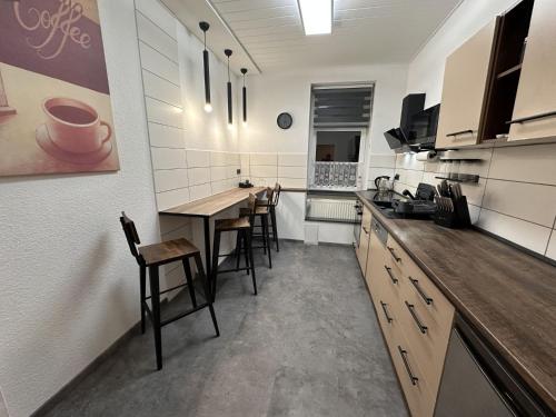 a kitchen with a table and some chairs in it at FeWo BiBo in Freiberg