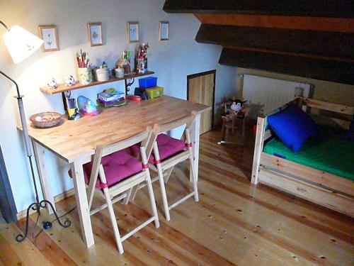 a dining room with a wooden table and chairs at Port del Comte a pie de pistas in La Coma i la Pedra