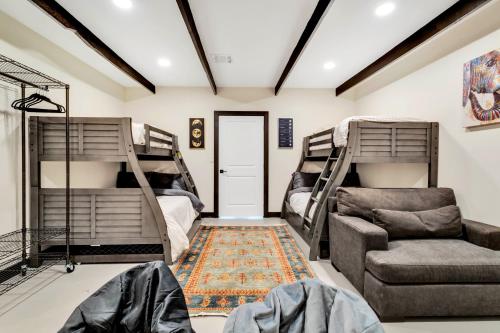 a room with two bunk beds and a couch at Joshua Tree Pool/Spa Villa in Joshua Tree