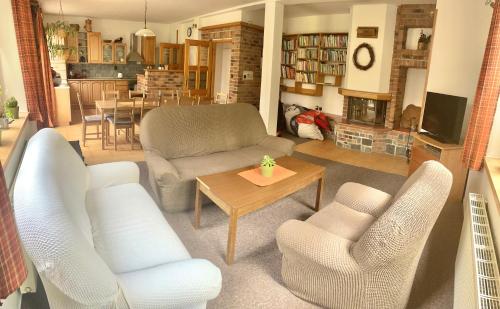 a living room with a couch and chairs and a table at Rekreační dům Pod Třešní Střílky in Střílky
