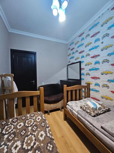 a bedroom with two beds and a wall with a fish mural at Guesthouse different in Tbilisi City