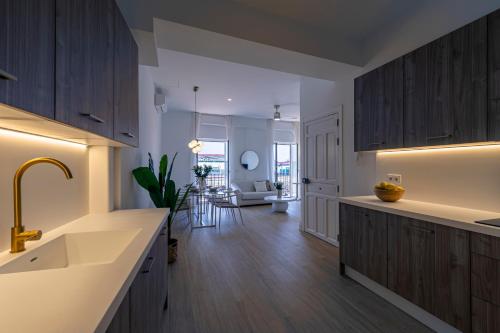 a kitchen with wooden cabinets and a dining room at ISG Apartments Faustino 45 in Seville