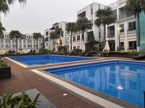 a swimming pool in front of a building at Shine HolliDay Villa HaNoi in Hanoi