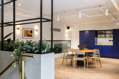 a dining room with a table and chairs at Magnificent Apartments at Ten Degrees in Croydon in Croydon