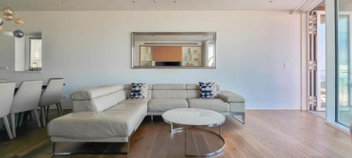 ein Wohnzimmer mit einem Sofa und einem Tisch in der Unterkunft BnBIsrael apartments - Hayarkon Emeraude in Tel Aviv