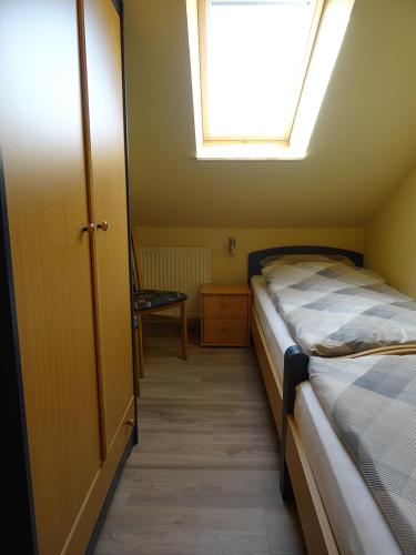 a small bedroom with two beds and a window at Clemens 1 in Wangerooge