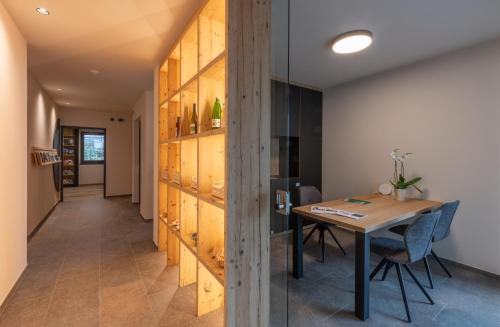 a dining room with a table and a wooden wall at Malojerhof in Lana