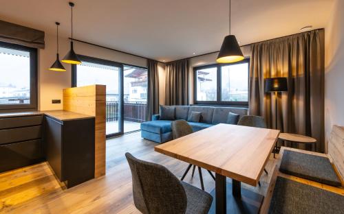 a living room with a table and a couch at Malojerhof in Lana