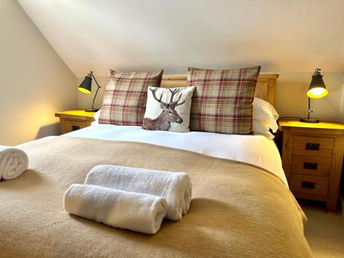 a bedroom with a bed with two towels on it at The Manor at Abberley in Abberley