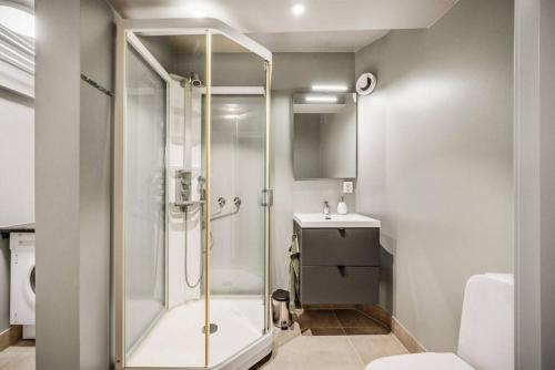 a bathroom with a shower and a sink at Dinbnb Apartments I Romantic Surroundings in The City Center in Bergen