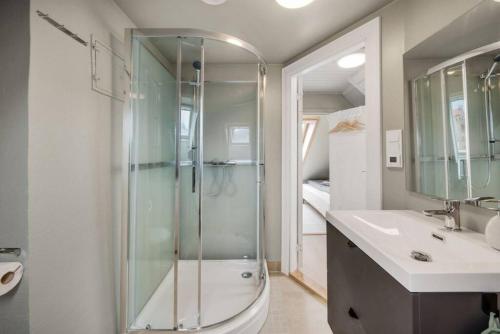 a bathroom with a shower and a toilet and a sink at Dinbnb Apartments I Romantic Surrourings in Bergen