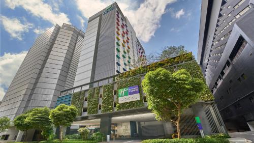 a building with plants on the side of it at Holiday Inn Express Singapore Orchard Road by IHG in Singapore