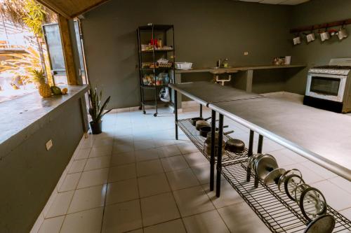 a kitchen with a table and chairs in it at Hostel Villa Vento Surf in Santa Catalina