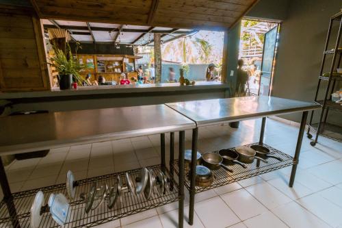 a kitchen with a counter with pots and pans at Hostel Villa Vento Surf in Santa Catalina