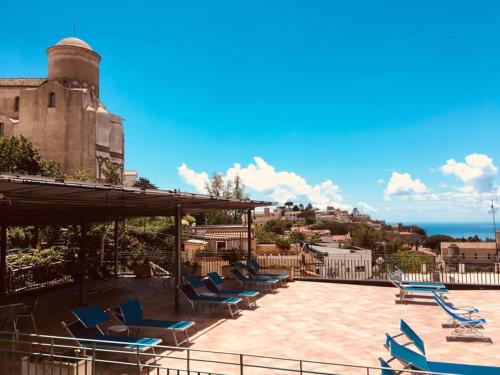 a group of blue lounge chairs on the roof of a building at Residence Le Villette in Ravello