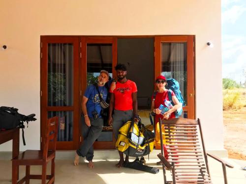 a group of people standing outside of a building at MONI FARM HOUSE WILPATTU in Nochchiyagama