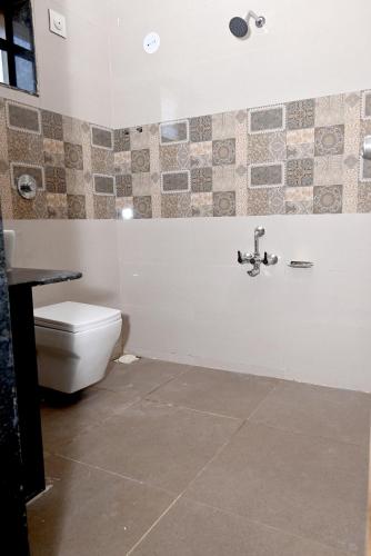 a bathroom with a toilet and a sink at Exotic Oceanview in Malvan