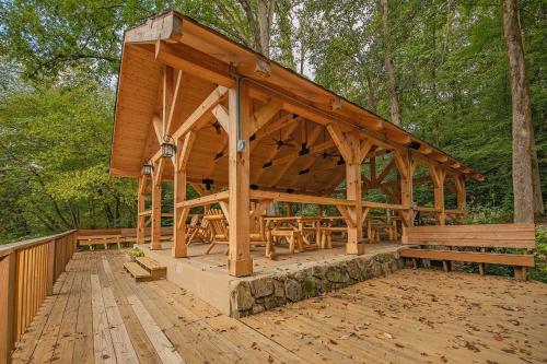 a wooden pavilion with benches on a wooden deck at Creek Crest Cabin Ocoee Riverside Cabin in Ocoee