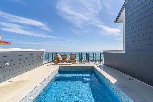 a swimming pool on the balcony of a house at Wait'n on Sundown in Destin