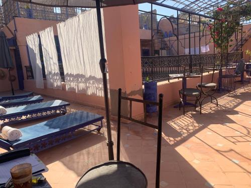 a balcony with two beds in a building at Riad Blue Berber in Marrakech