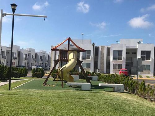 a playground in a park with a slide at Departamento Los Héroes Veracruz in Veracruz